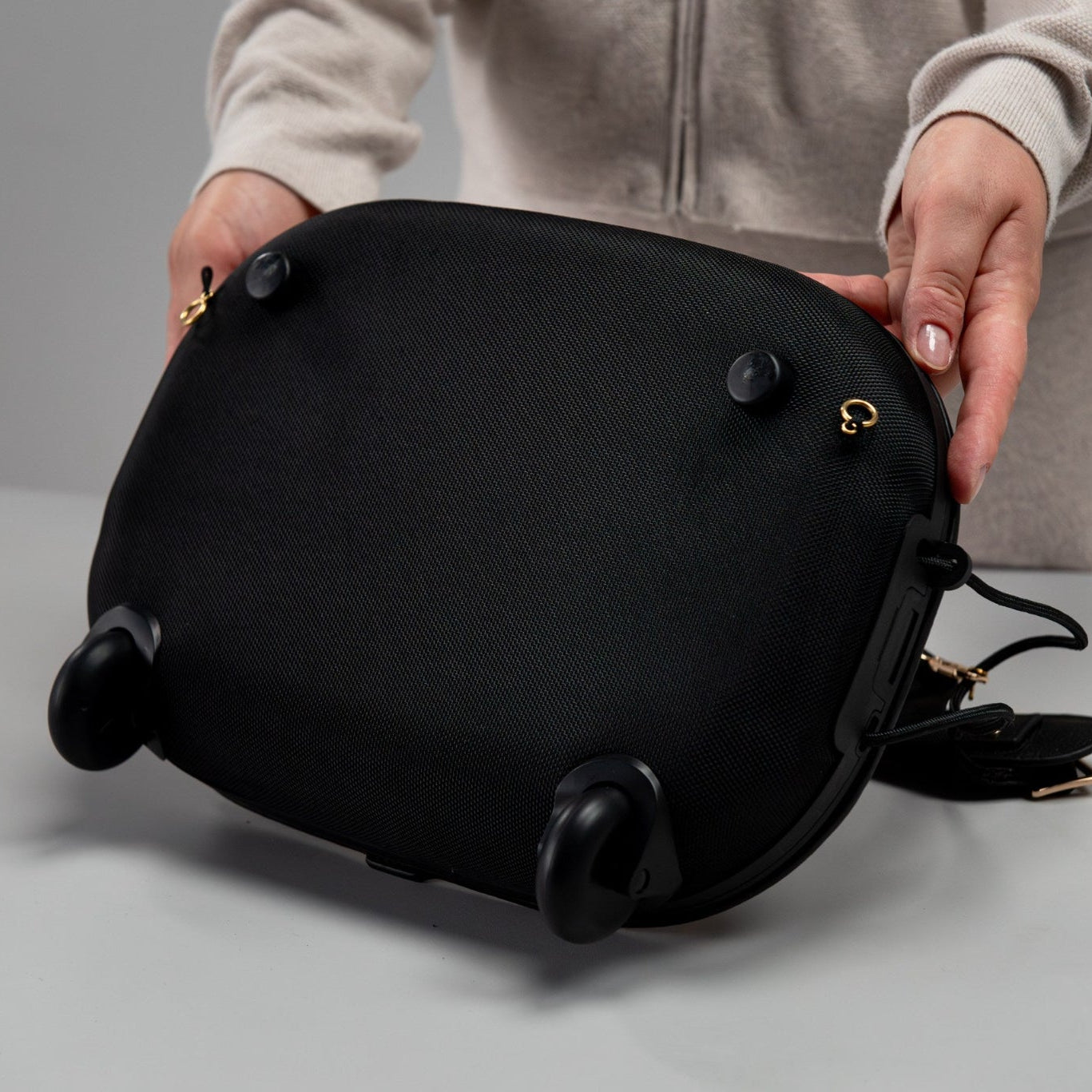 Olla Bag EVA base with two wheels and two support legs, shown in black