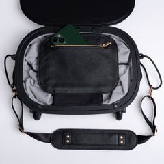 Olla Bag in handbag configuration with top lid open, showing internal zip pocket and phone inside