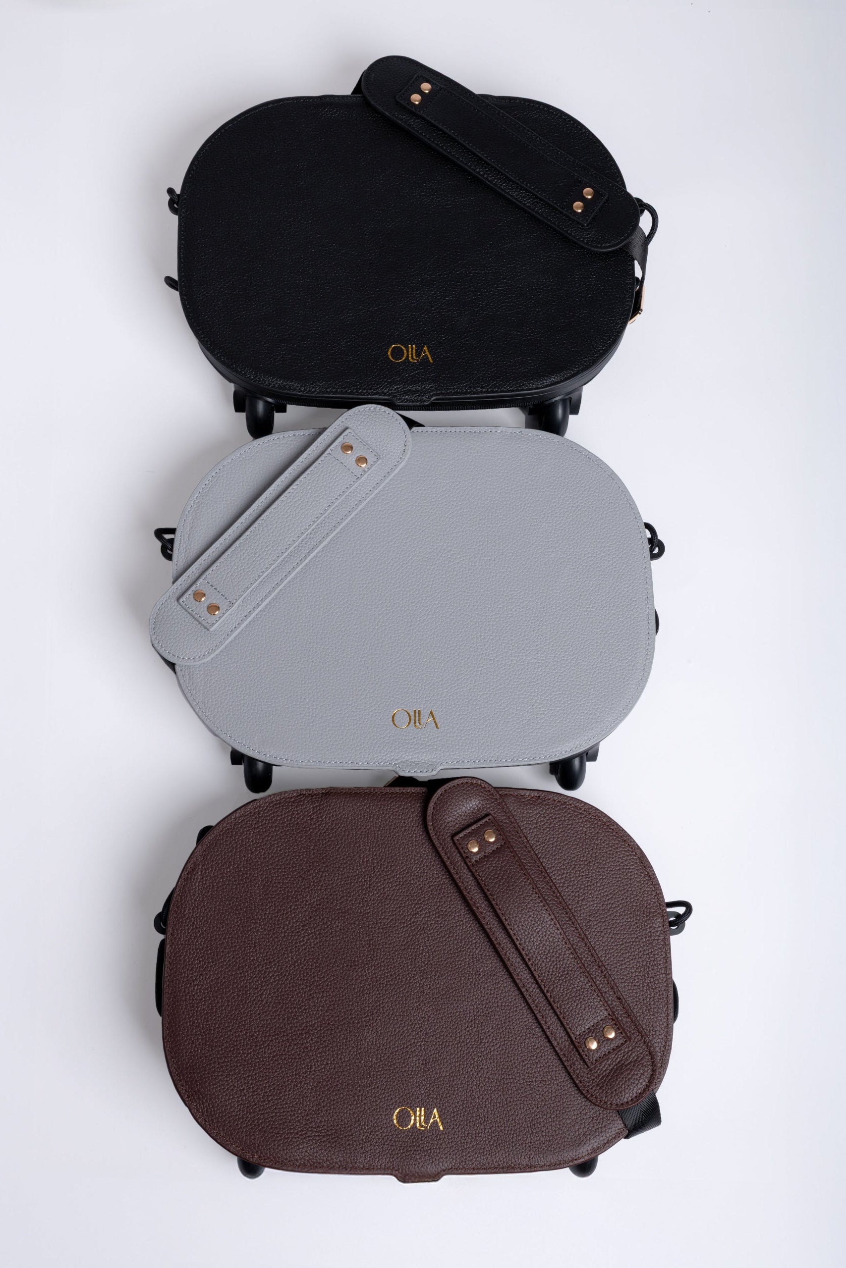 Three bags in black, gray, and brown stacked on a white background with 'Olla' branding.