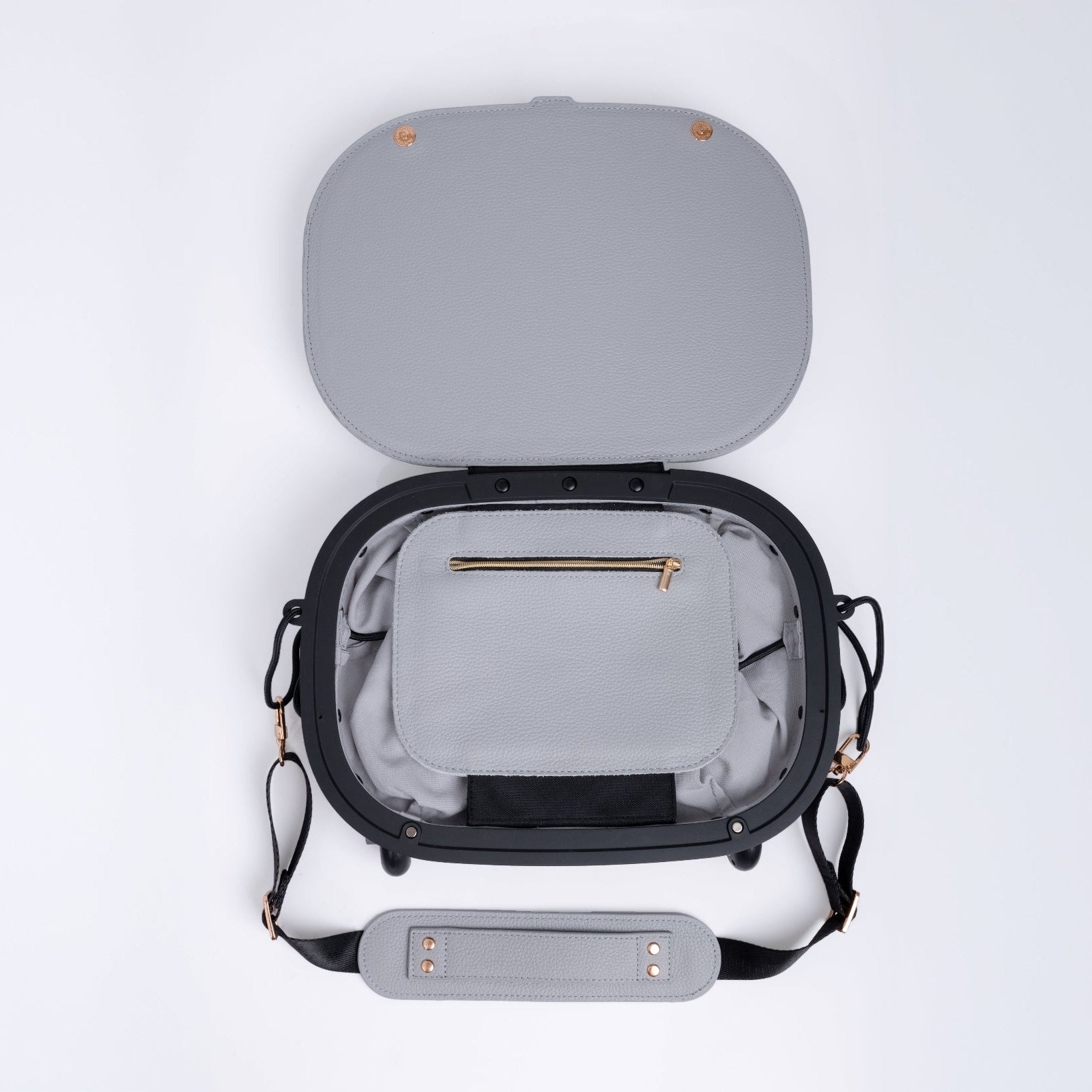 Gray leather travel bag with open lid on a white background. Small internal pocket with a zip.