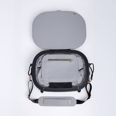 Gray leather travel bag with open lid on a white background. Small internal pocket with a zip.