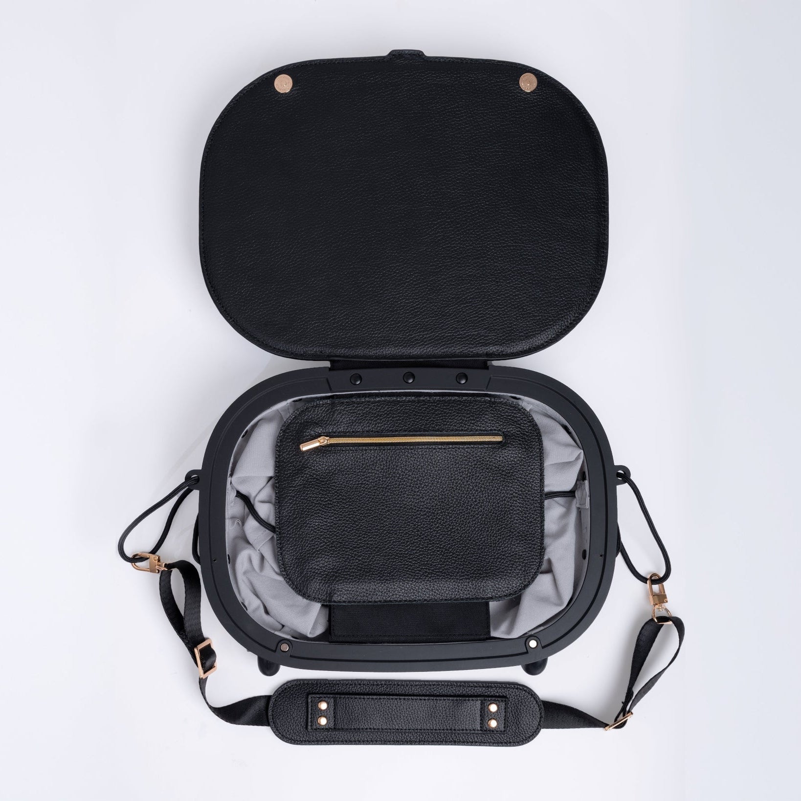 Black leather travel bag with open lid on a white background. Small internal pocket with a zip.