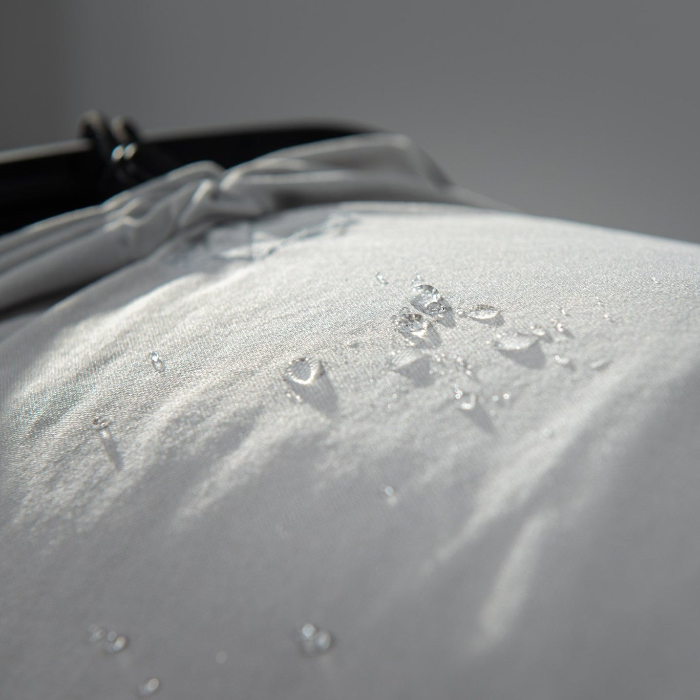 Close-up of Olla Bag’s Cordura fabric trolley showing water resistance with water droplets on the surface