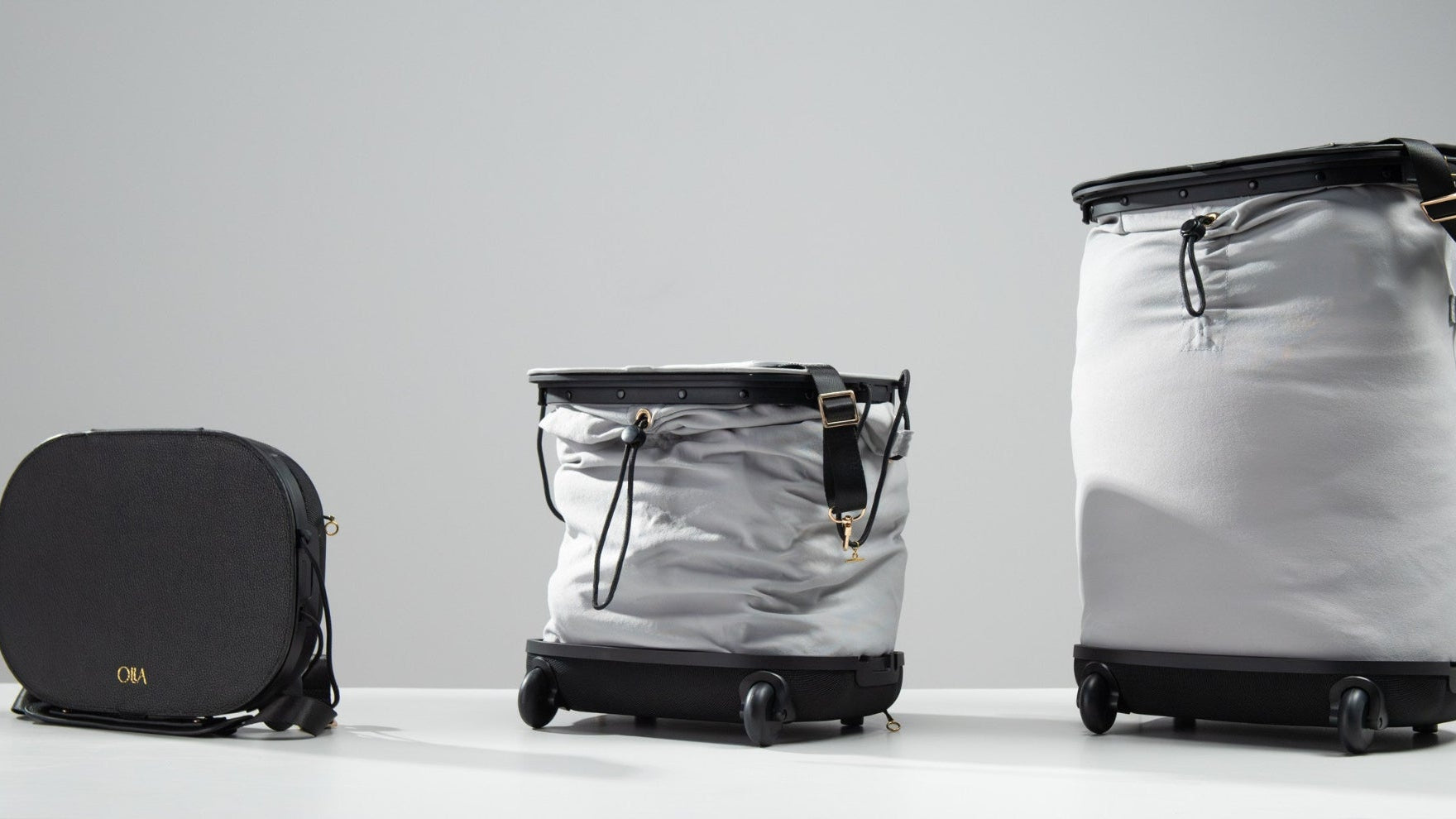Olla Bag shown in three configurations: compact handbag, medium trolley, and large trolley, highlighting its convertible design