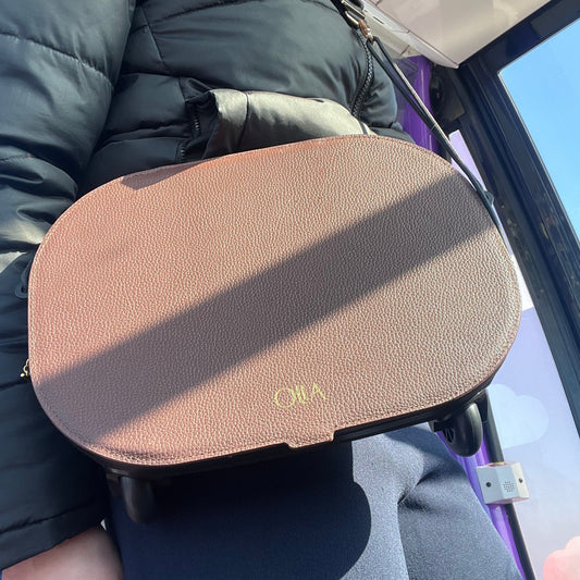 women in a cable cars with a handbag  with 'olla' branding.