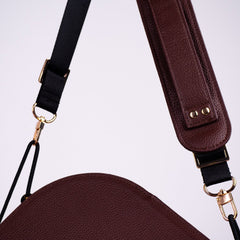 Adjustable Olla Bag strap with gold-finish hardware and brown leather shoulder pad